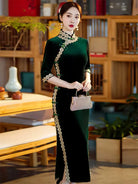 Lace edged velvet cheongsam in emerald green with lace trim and jade frog buttons