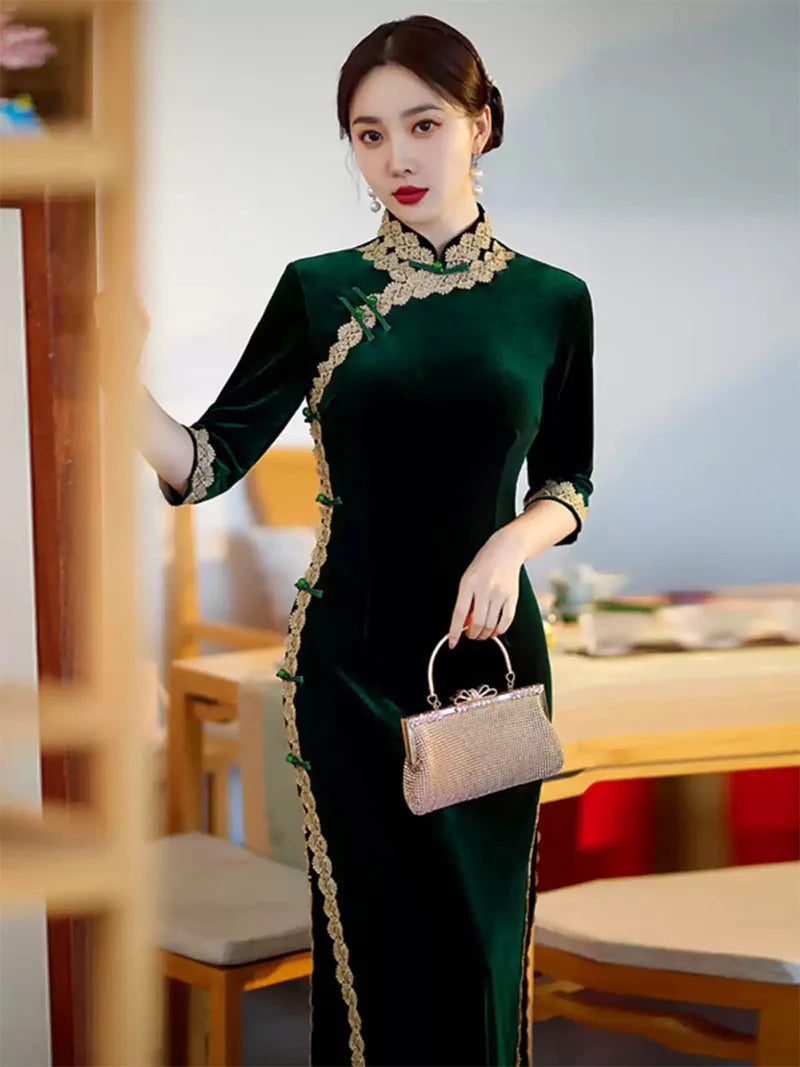 Lace edged velvet cheongsam in emerald green with lace trim and jade frog buttons