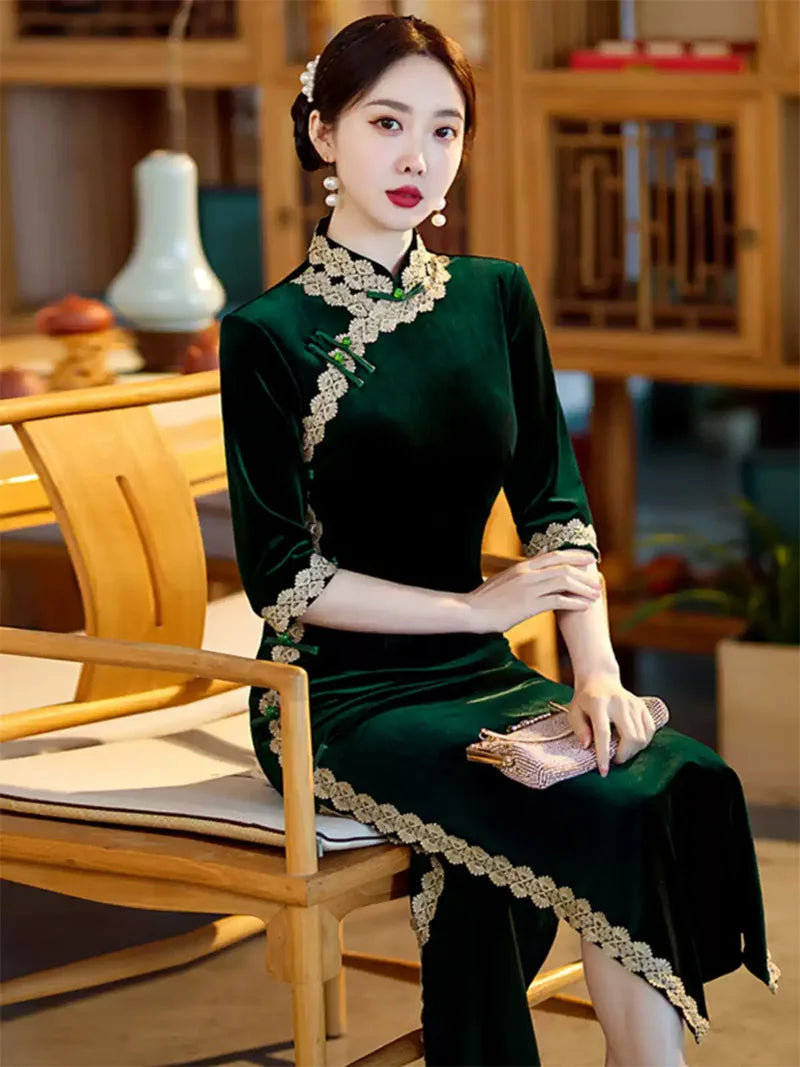 Lace edged velvet cheongsam in emerald green with lace trim and jade frog buttons