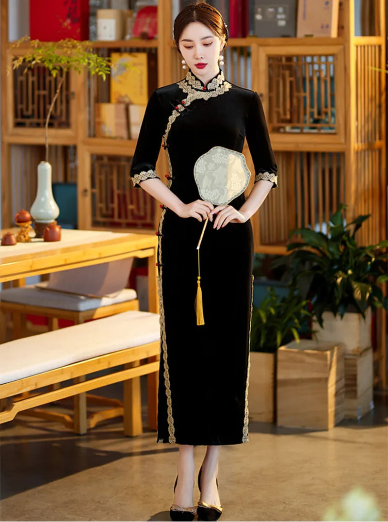Lace edged velvet cheongsam in emerald green with lace trim and jade frog buttons