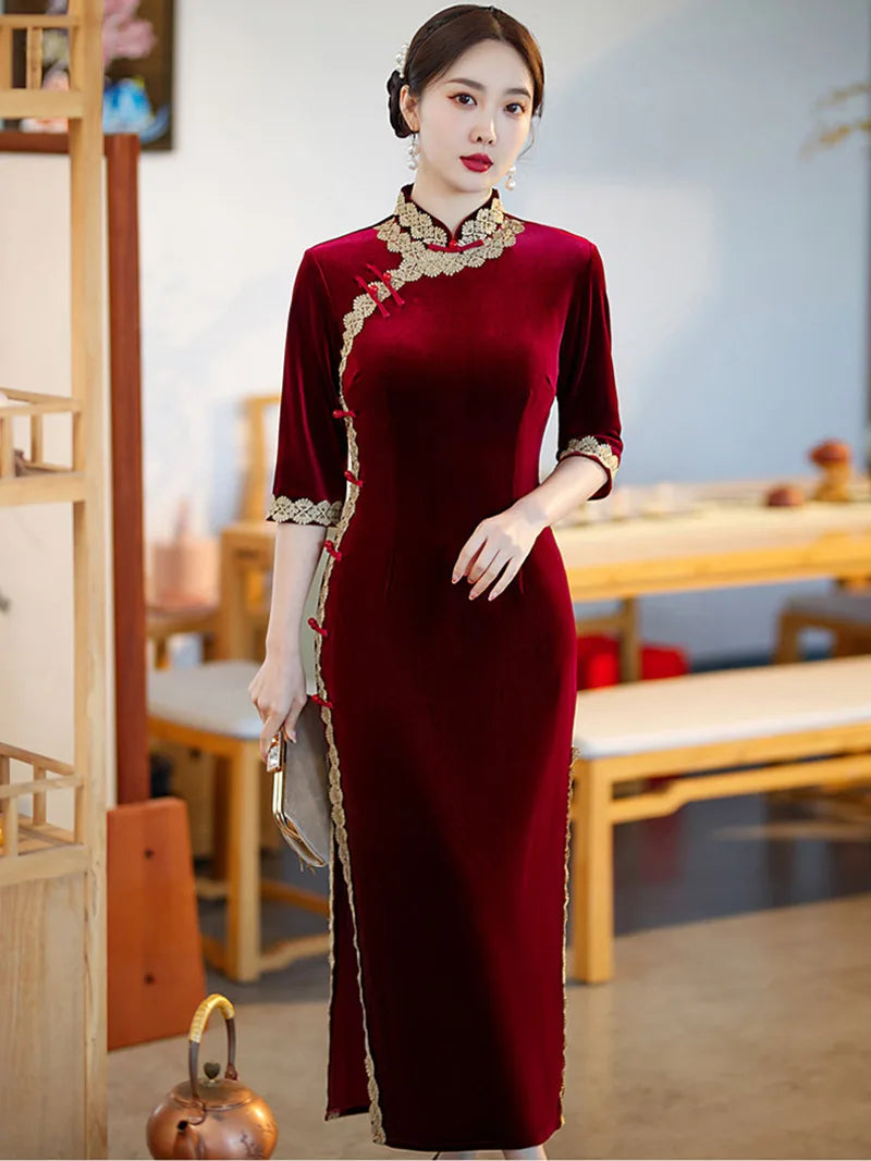 Lace edged velvet cheongsam in emerald green with lace trim and jade frog buttons