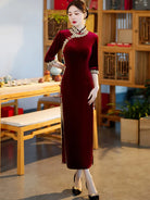 Lace edged velvet cheongsam in emerald green with lace trim and jade frog buttons