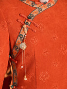 Festive orange fleece-lined winter cheongsam designed for warmth and youthful Chinese style