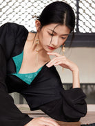 Model holding out the rust-orange hanfu skirt to show its wide flowing panels