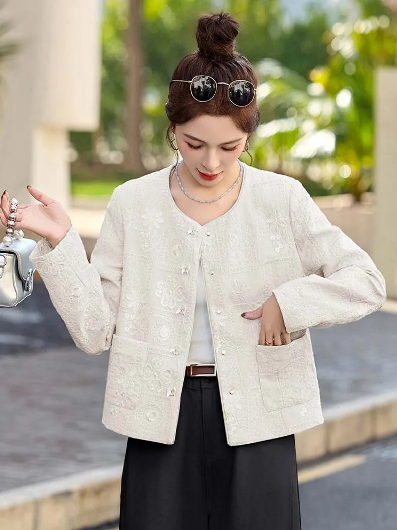 Blue Tang suit for women featuring exquisite embroidery, elegant short design, and modern Chinese fashion charm.