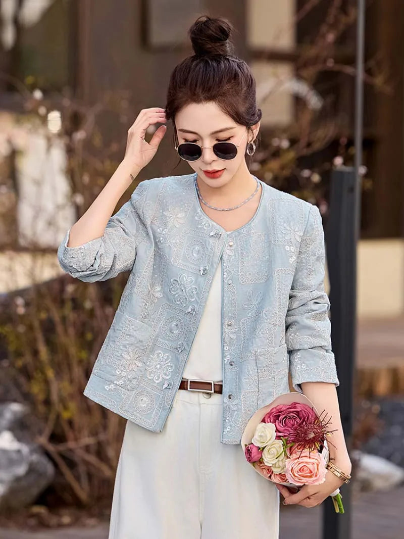 Blue Tang suit for women featuring exquisite embroidery, elegant short design, and modern Chinese fashion charm.