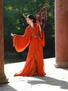 Red Chinese hanfu dress with trailing hem inspired by Warring States robe, featuring wide sleeves and traditional elegance