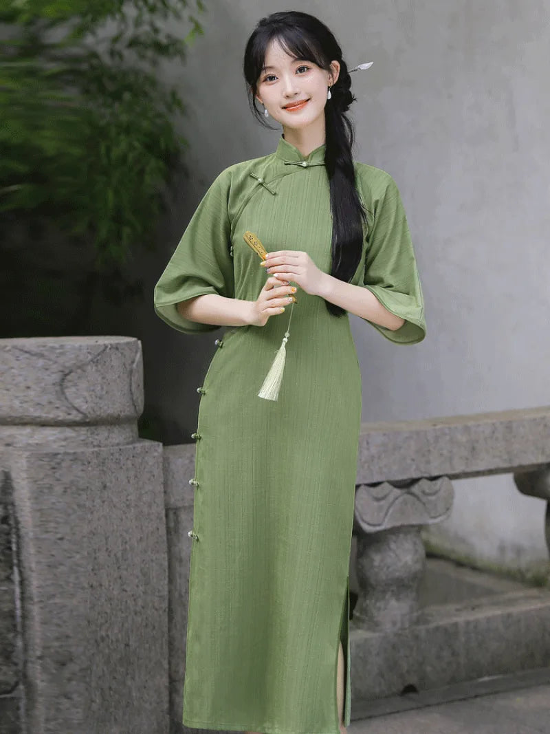 Elegant green qipao dress with full front opening and floor-length vintage Chinese design