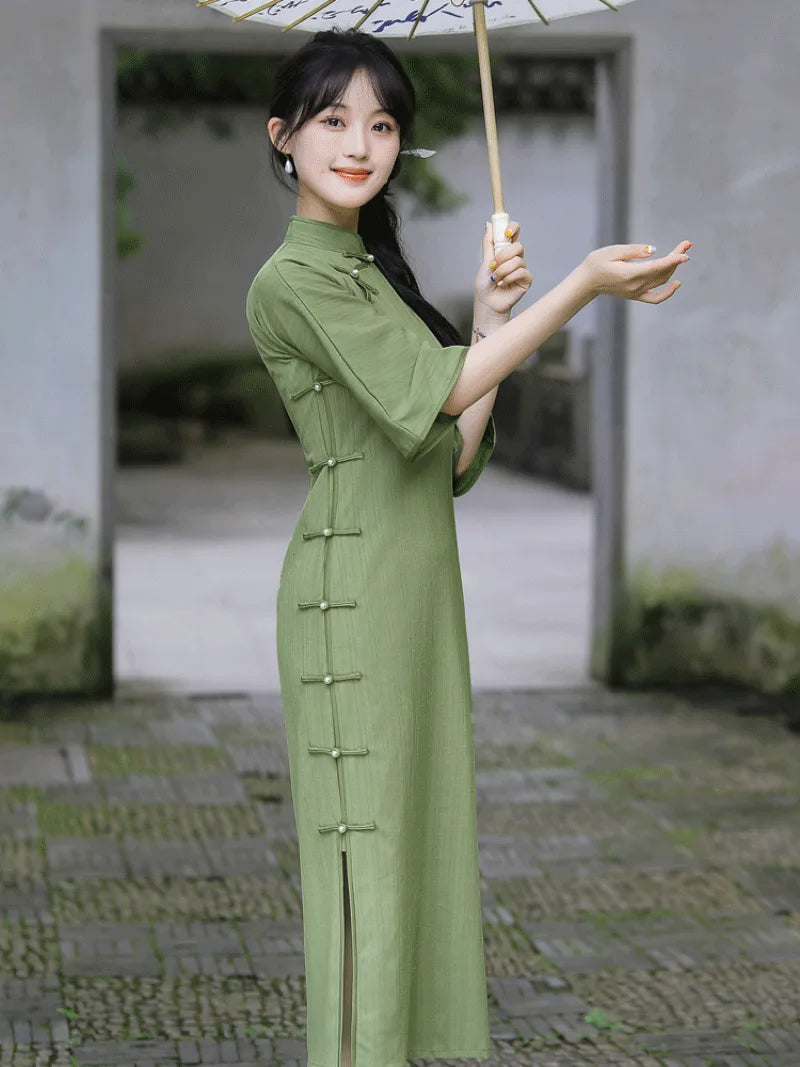 Elegant green qipao dress with full front opening and floor-length vintage Chinese design