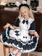 Classic black and white Lolita maid dress with lace apron and bow details, elegant original design