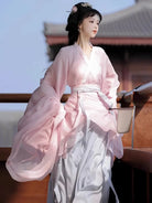 Elegant pink hanfu dress with wide sleeves, flowing fabric, and fairy-like ancient Chinese style for women
