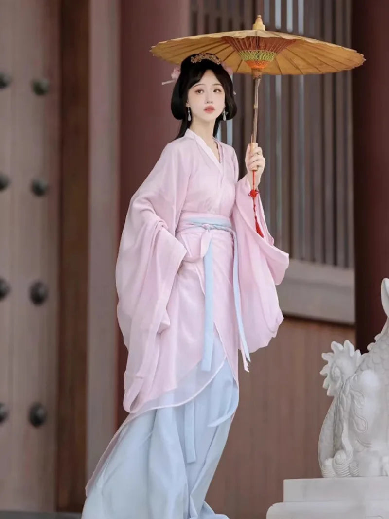 Elegant pink hanfu dress with wide sleeves, flowing fabric, and fairy-like ancient Chinese style for women