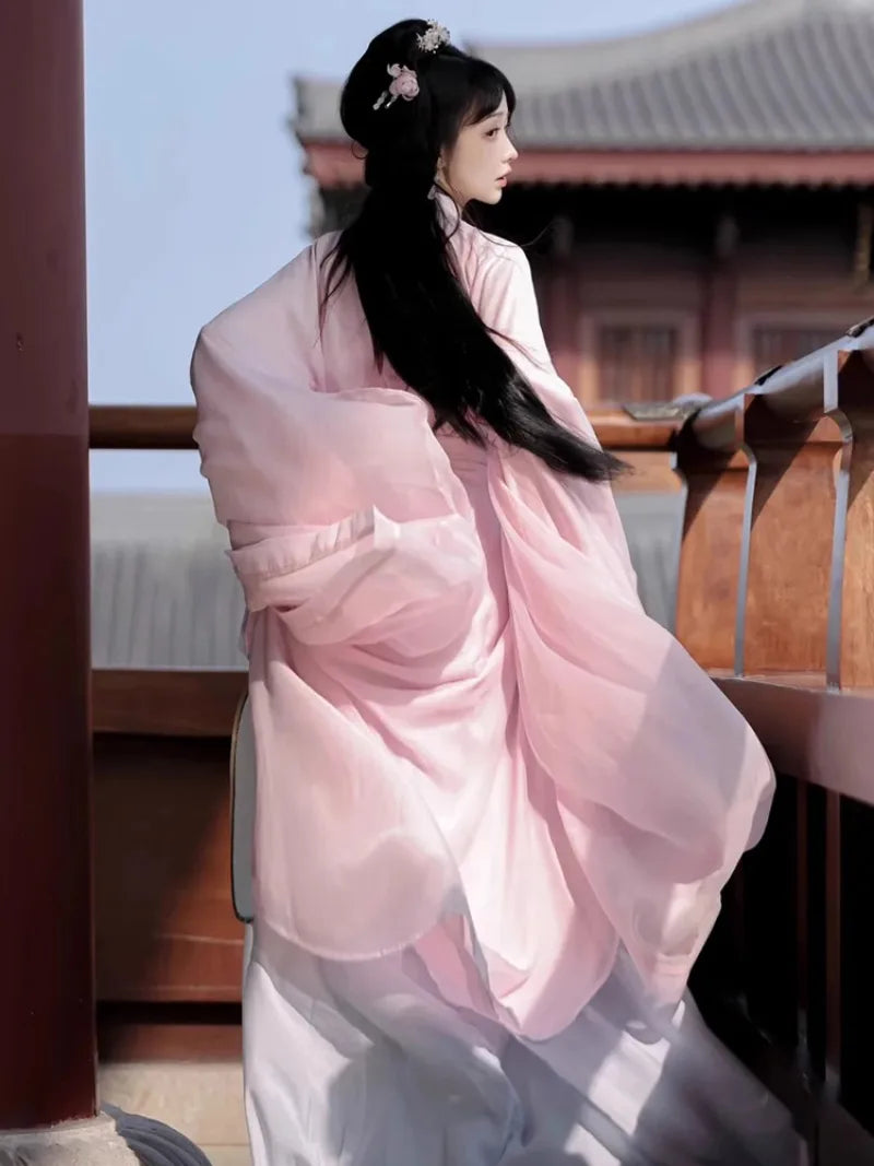 Elegant pink hanfu dress with wide sleeves, flowing fabric, and fairy-like ancient Chinese style for women