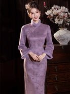 Warm purple winter qipao featuring soft suede fabric and a refined modern Chinese silhouette.