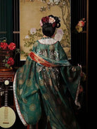 Restored tang dynasty hanfu dress featuring wide sleeves and colorful red gradient skirt patterns.