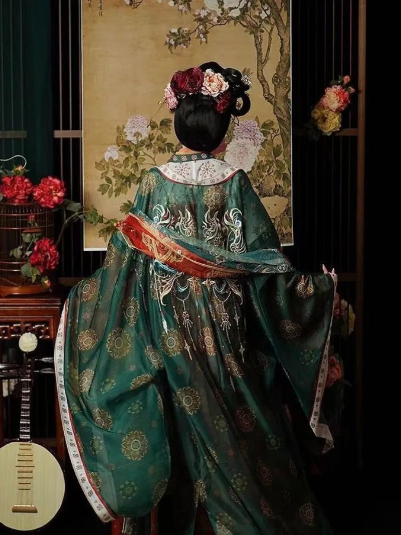 Restored tang dynasty hanfu dress featuring wide sleeves and colorful red gradient skirt patterns.