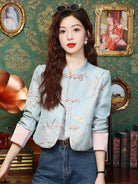 Elegant modern Tang jacket for women with embroidery, jacquard fabric, and traditional frog button details