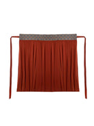 Model holding out the rust-orange hanfu skirt to show its wide flowing panels