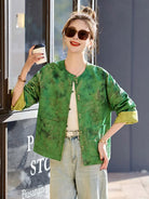 Elegant reversible Tang Suit for women featuring jacquard fabric, classic Chinese button design, and modern fashion silhouette.