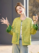 Elegant reversible Tang Suit for women featuring jacquard fabric, classic Chinese button design, and modern fashion silhouette.