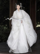 White hanfu outfit for women with wide sleeves and cross-collar design in ethereal traditional Chinese style