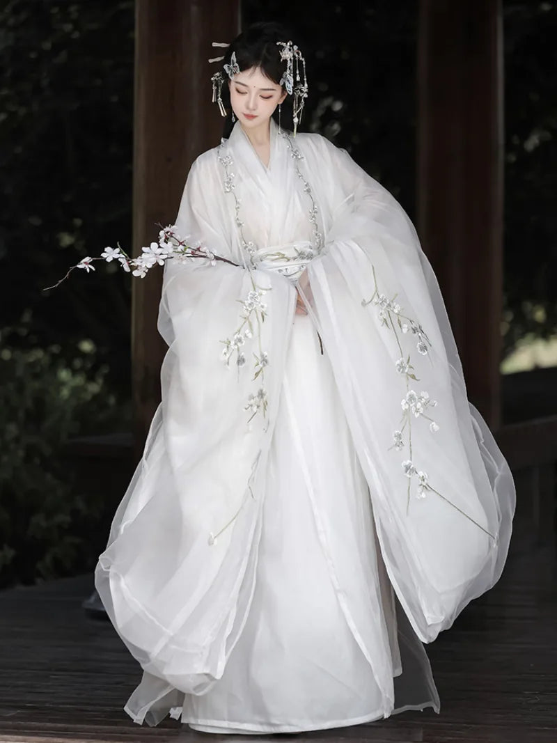 White hanfu outfit for women with wide sleeves and cross-collar design in ethereal traditional Chinese style